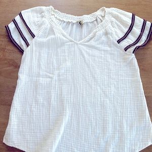 Cream top with sleeve embroidery accent